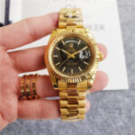 Rolex Yellow Gold Day-Date 40 Watch – Fluted Bezel – Black Baguette Diamond Dial – President Bracelet